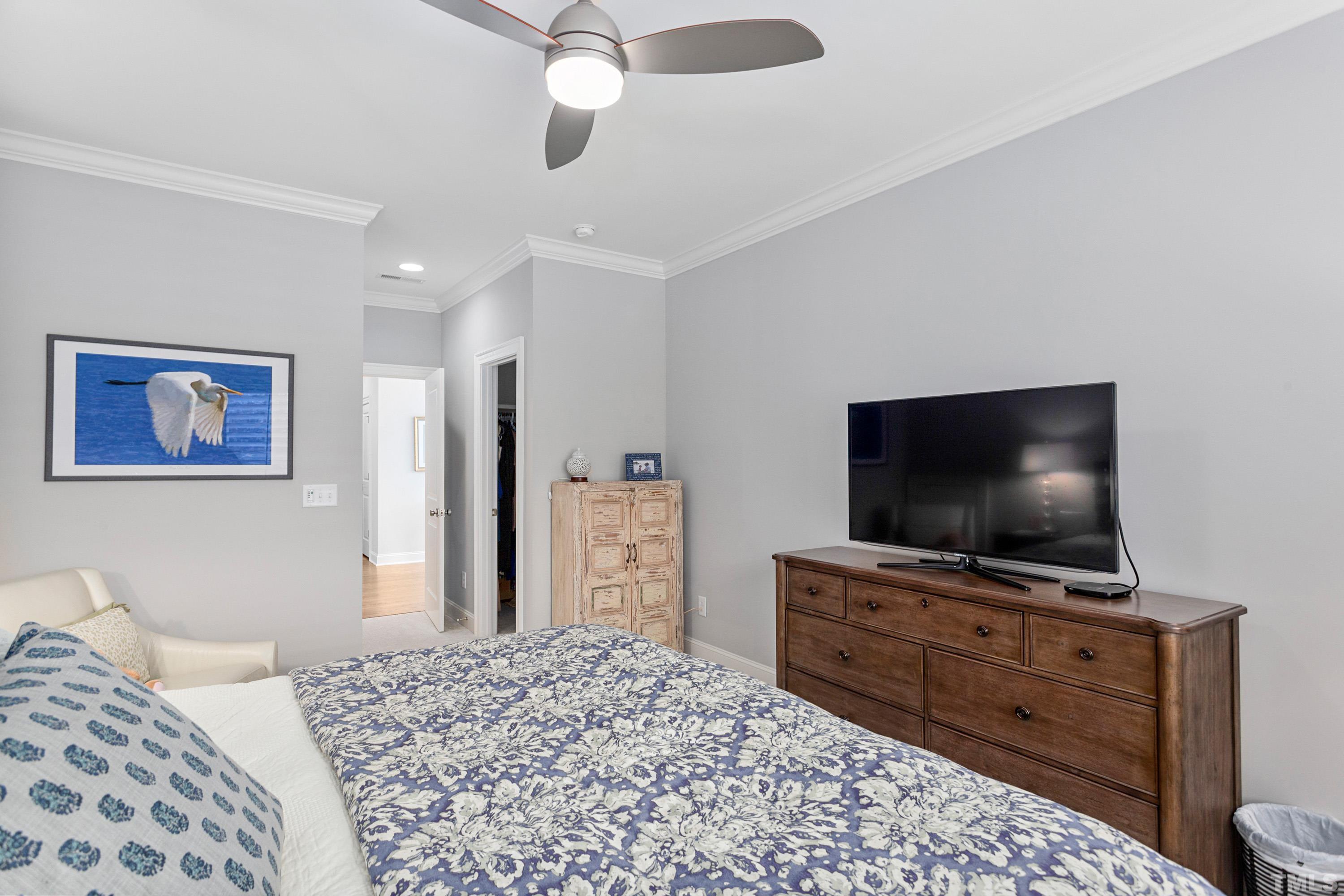 3013 Colmar Manor Drive Cary, NC 27519 - Photo 33 of 53 a bedroom with bed and a flat screen tv