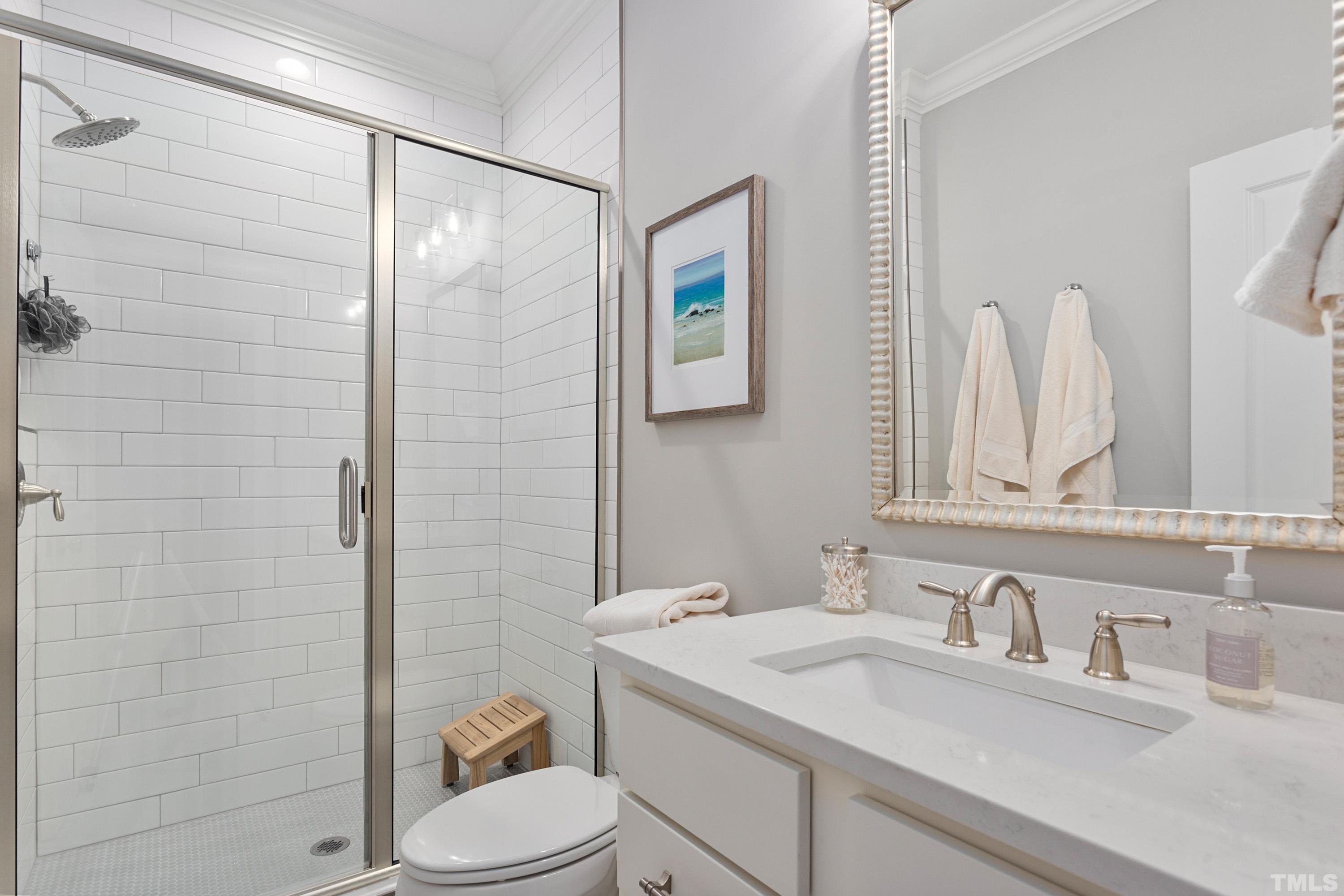 3013 Colmar Manor Drive Cary, NC 27519 - Photo 34 of 53 a bathroom with a granite countertop sink toilet and shower