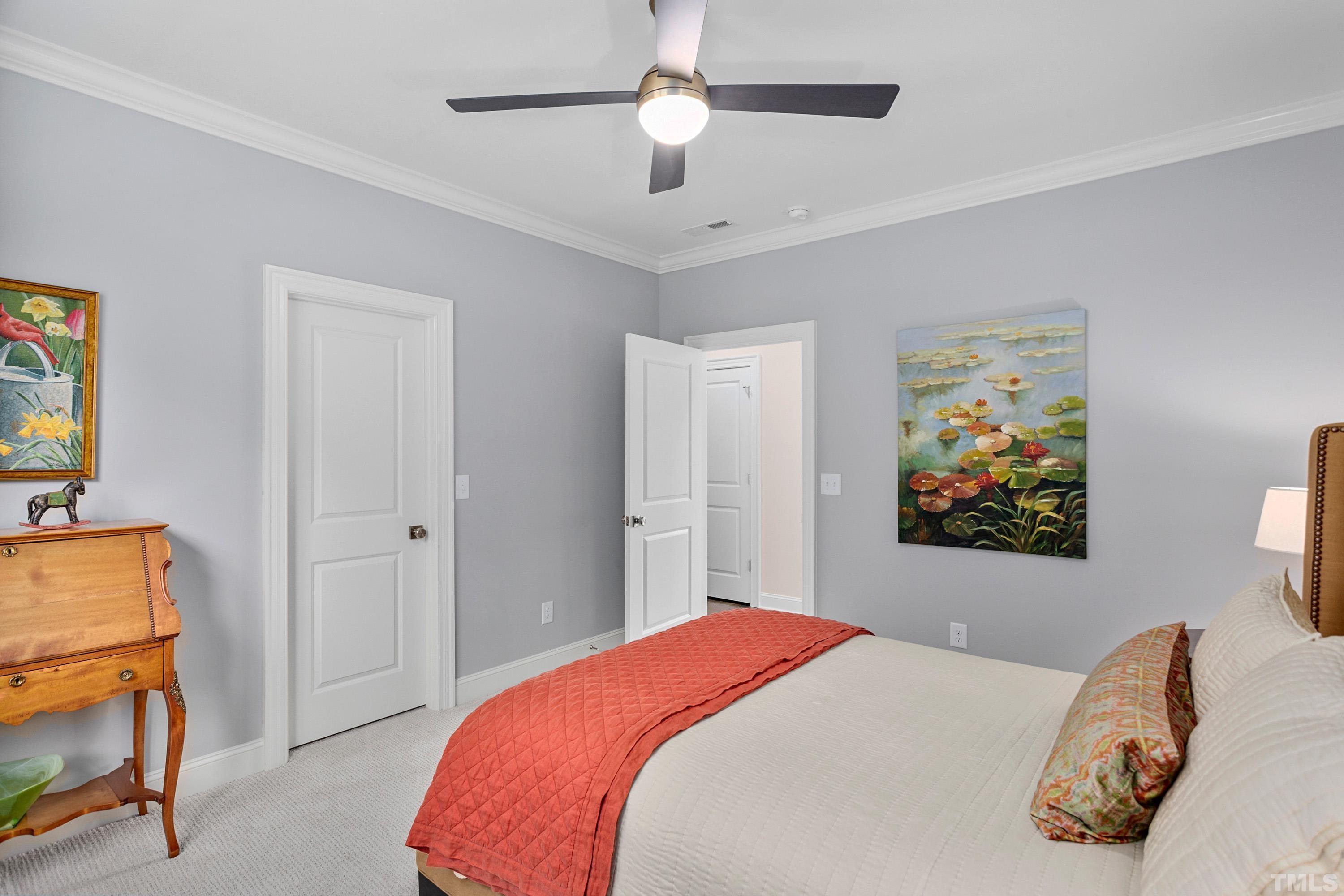 3013 Colmar Manor Drive Cary, NC 27519 - Photo 36 of 53 a bedroom with a bed and a chandelier