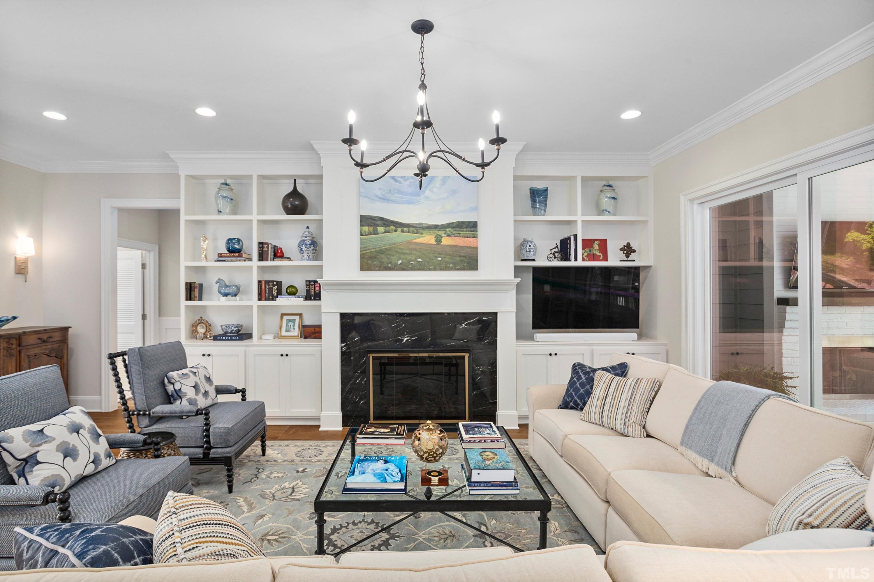 3013 Colmar Manor Drive Cary, NC 27519 - Photo 5 of 53 a living room with furniture a fireplace and a flat screen tv