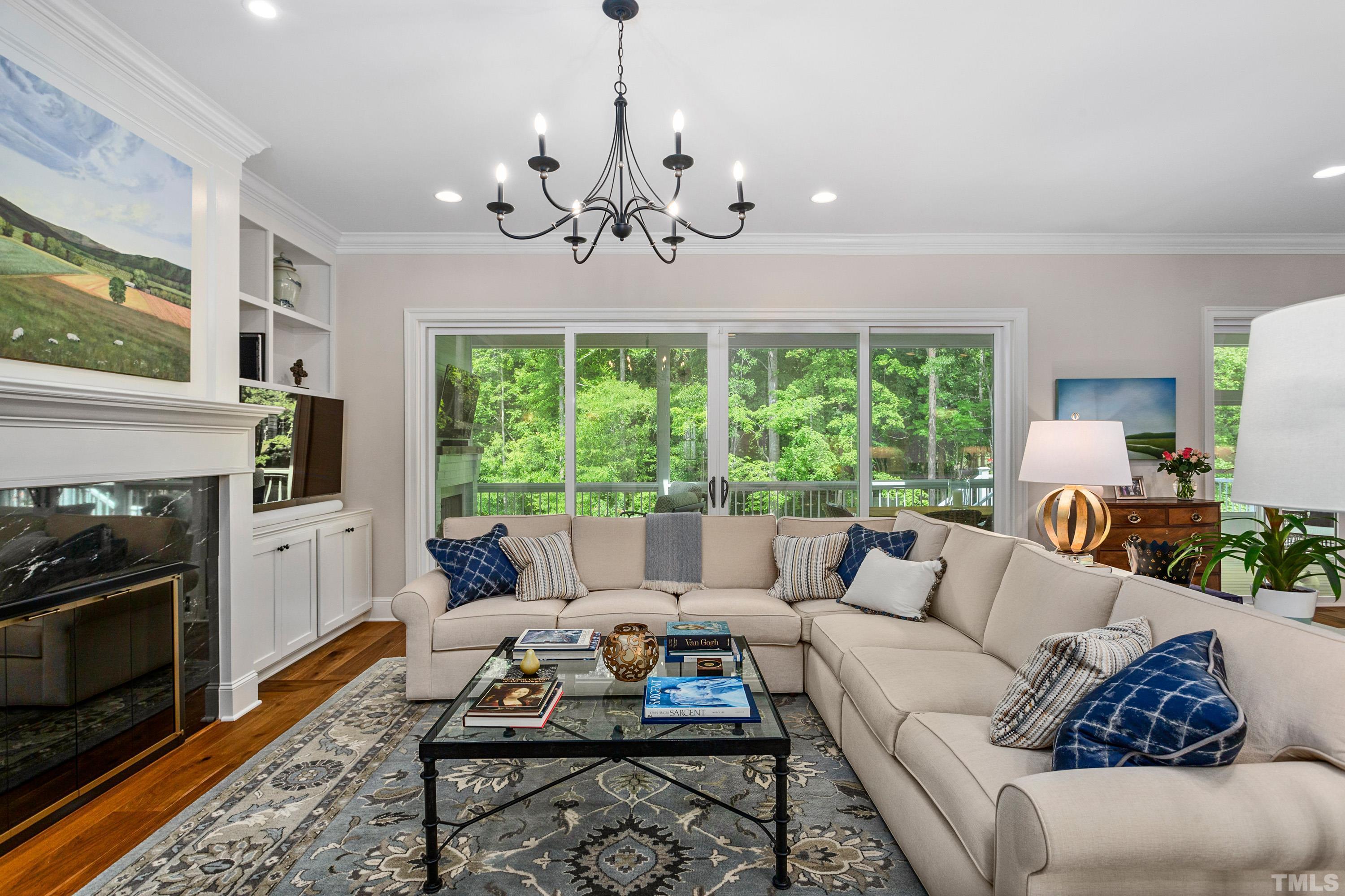 3013 Colmar Manor Drive Cary, NC 27519 - Photo 6 of 53 a living room with furniture chandelier and a flat screen tv