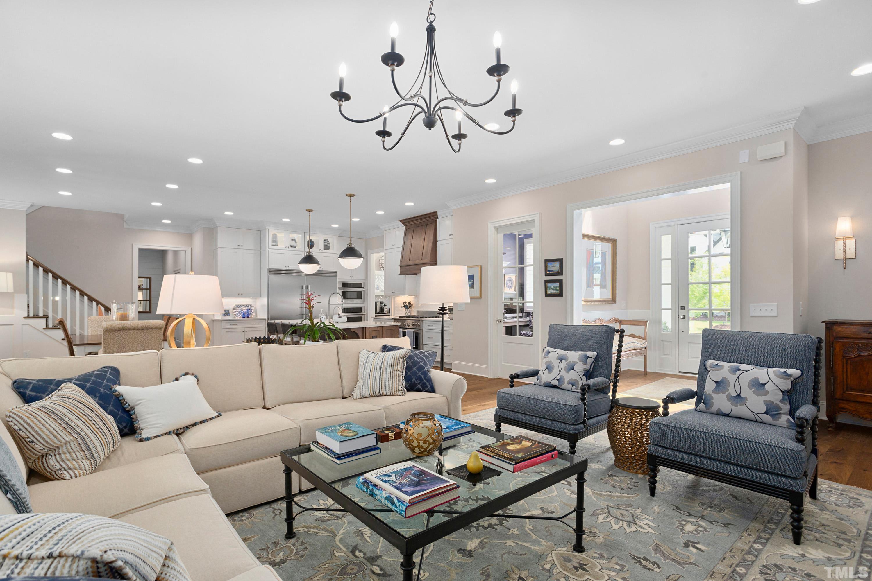 3013 Colmar Manor Drive Cary, NC 27519 - Photo 7 of 53 a living room with furniture kitchen view and a chandelier