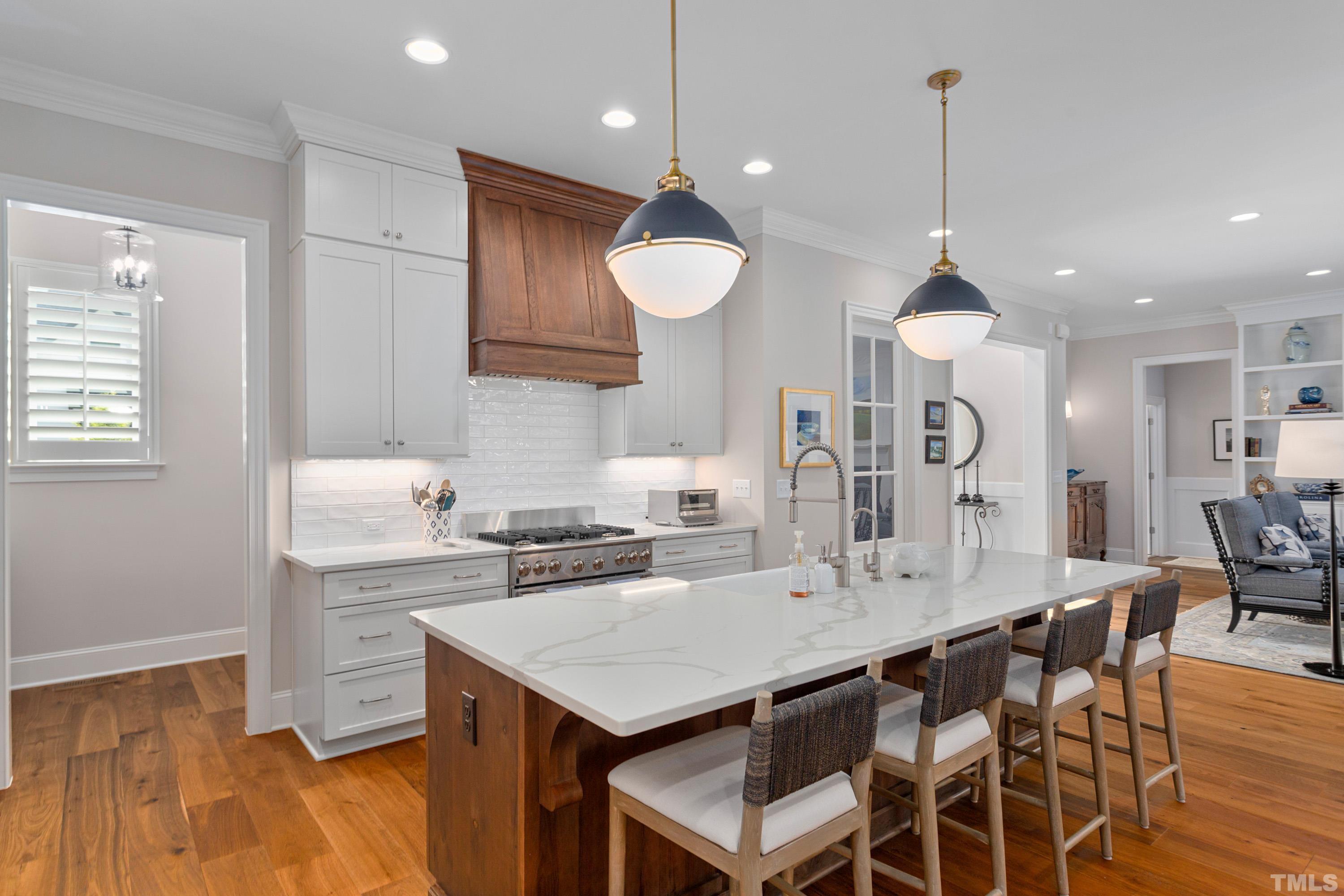 3013 Colmar Manor Drive Cary, NC 27519 - Photo 9 of 53 a kitchen with a table chairs sink and cabinets