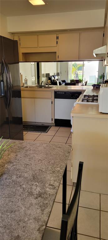 2218 Abbey Road Southwest Winter Haven, FL 33880 - Photo 6 of 31 a kitchen with stainless steel appliances granite countertop a stove a sink and a refrigerator