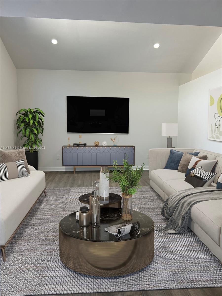 Three Lakes Miami, FL 33186 - Photo 11 of 32 a living room with furniture a flat screen tv and a large window