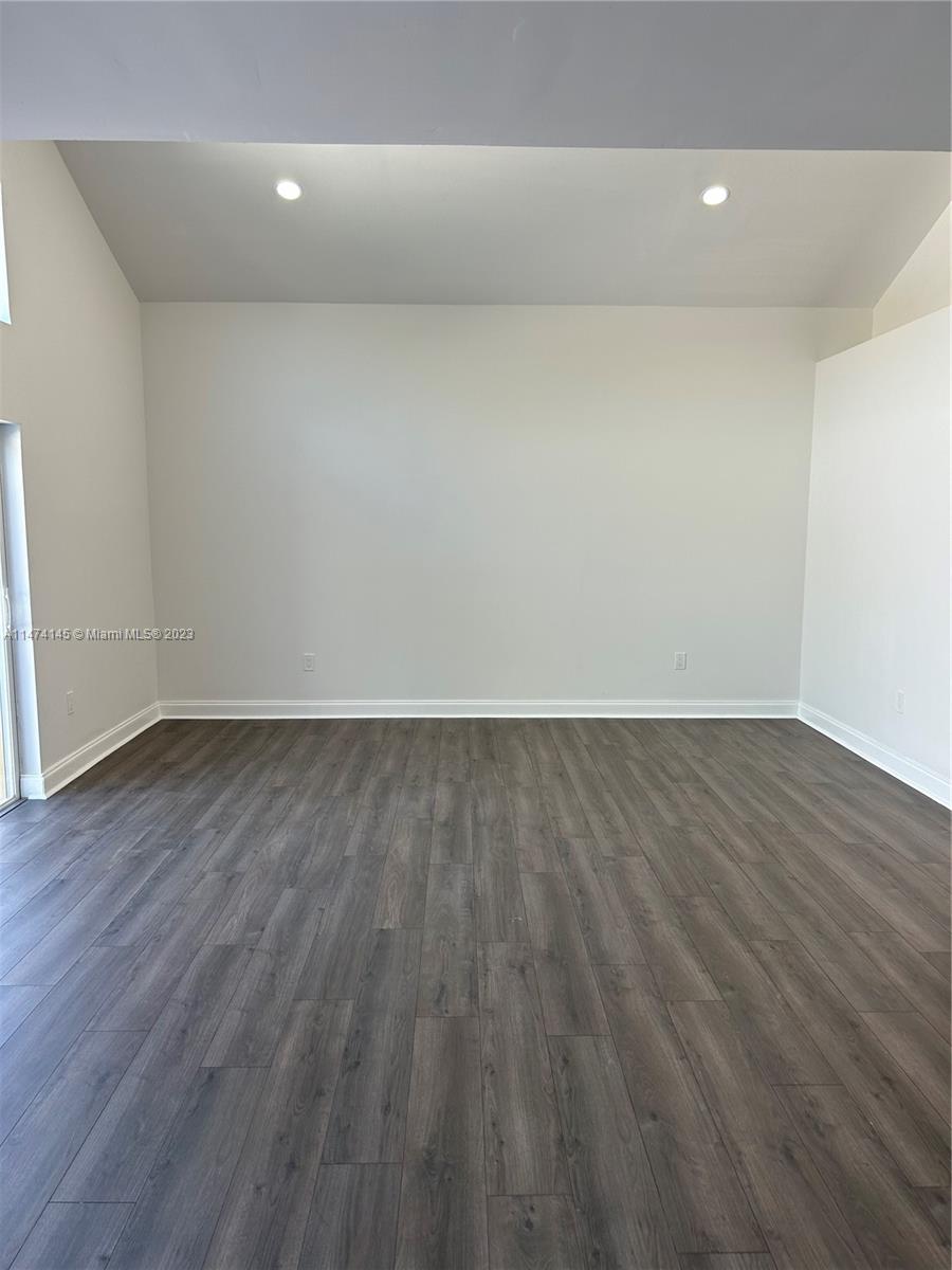 Three Lakes Miami, FL 33186 - Photo 12 of 32 a view of room with wooden floor and white walls