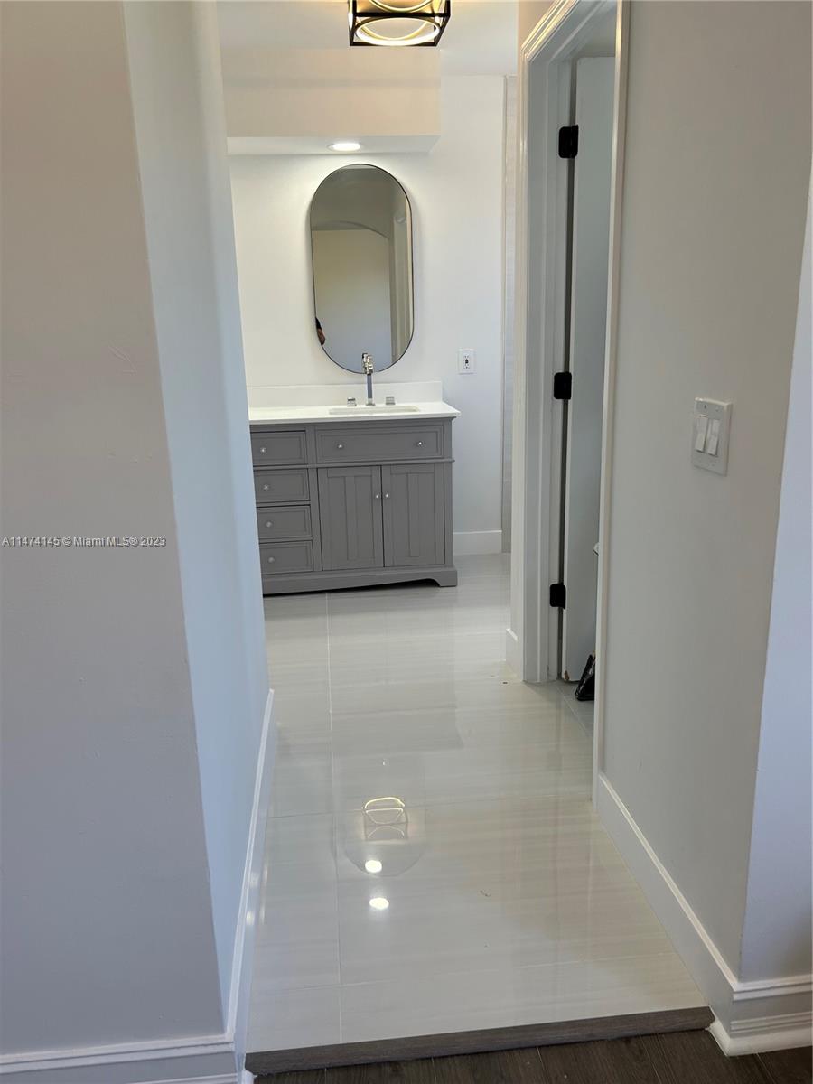 Three Lakes Miami, FL 33186 - Photo 14 of 32 a bathroom with a sink and a mirror
