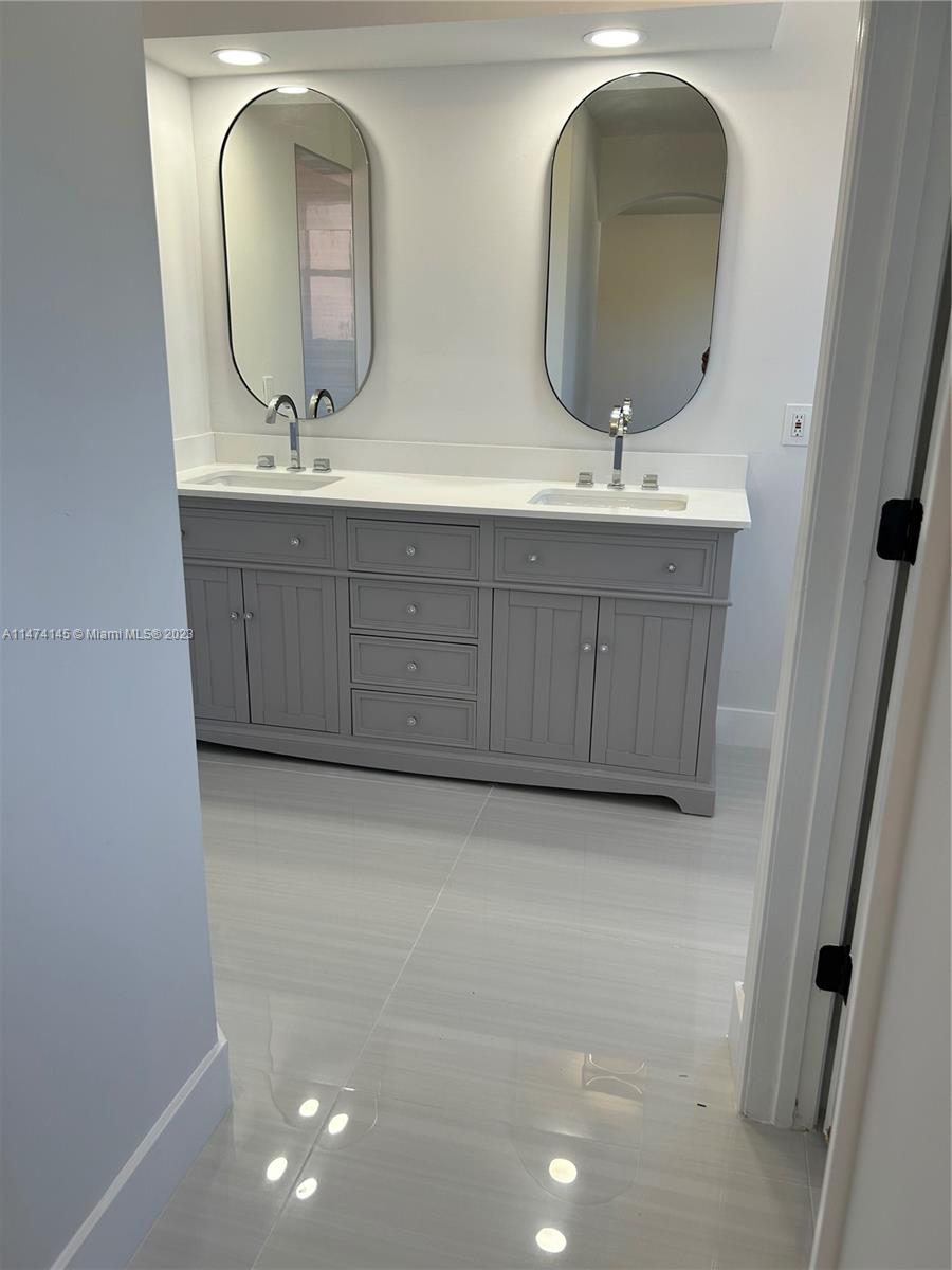 Three Lakes Miami, FL 33186 - Photo 15 of 32 a bathroom with a double vanity sink and a mirror