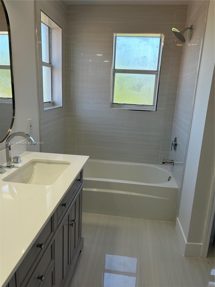 Three Lakes Miami, FL 33186 - Photo 18 of 32 a bathroom with a tub a sink and a mirror