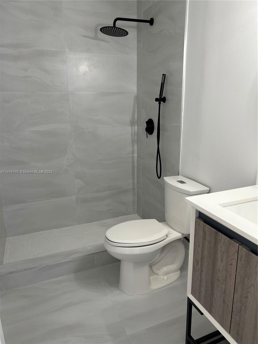 Three Lakes Miami, FL 33186 - Photo 19 of 32 a white toilet sitting next to a bathroom sink