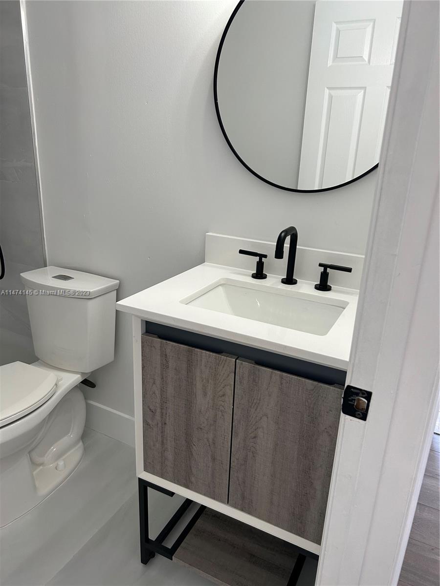 Three Lakes Miami, FL 33186 - Photo 20 of 32 a bathroom with a sink toilet and a mirror