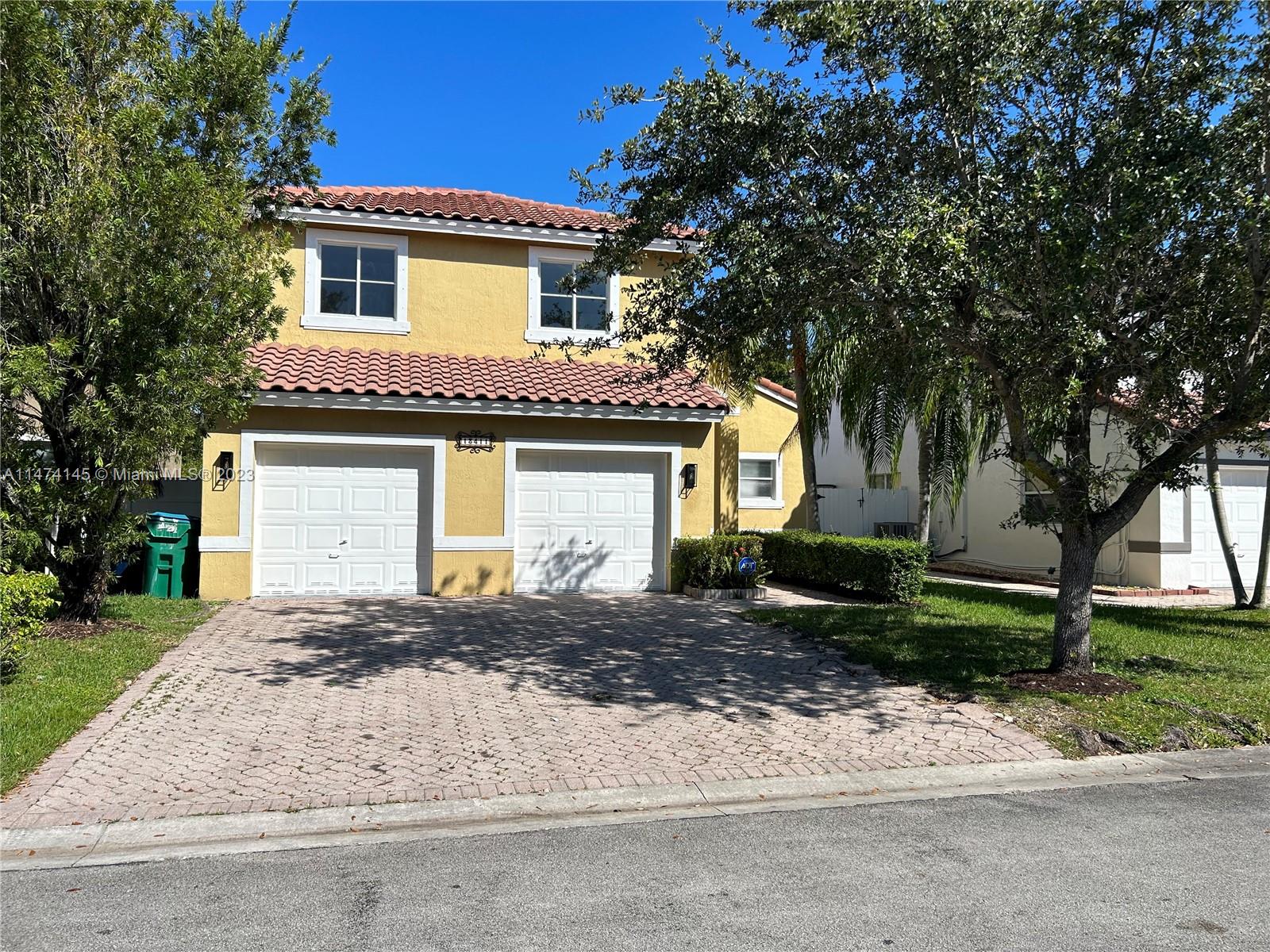 Three Lakes Miami, FL 33186 - Photo 22 of 32 a front view of a house with a yard and garage