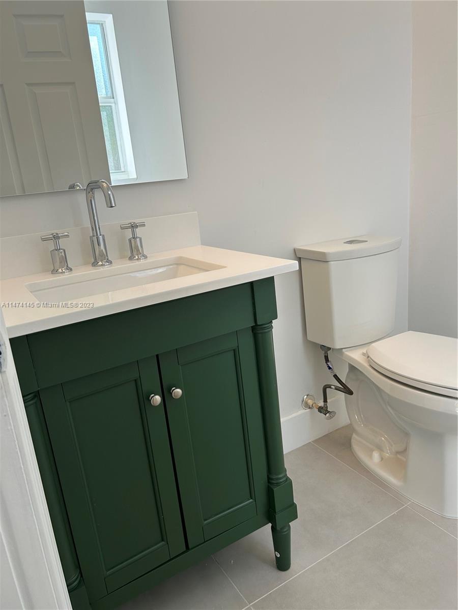 Three Lakes Miami, FL 33186 - Photo 26 of 32 a bathroom with a sink toilet and mirror