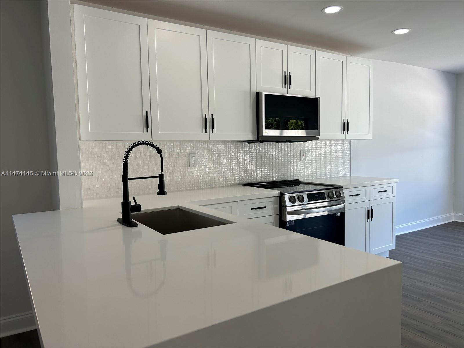 Three Lakes Miami, FL 33186 - Photo 3 of 32 a kitchen with granite countertop a stove and a sink