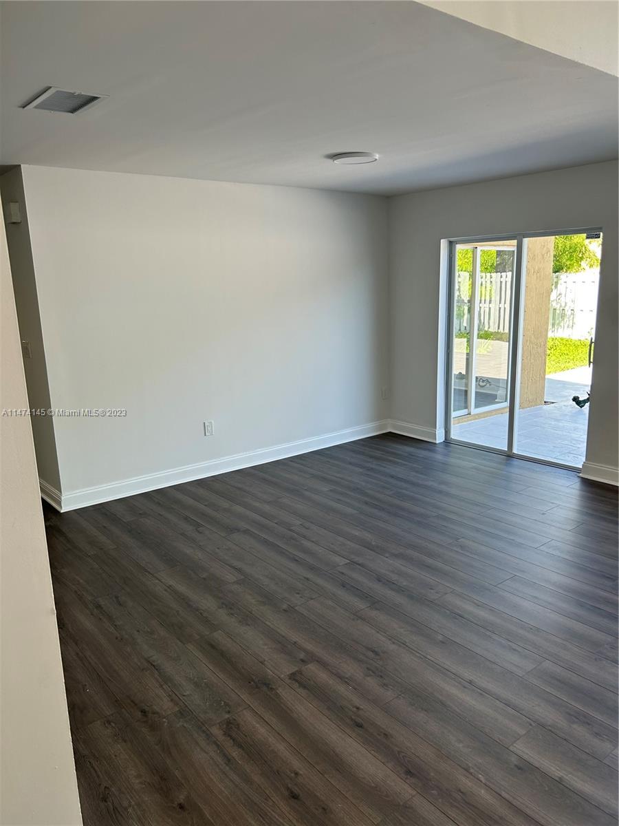 Three Lakes Miami, FL 33186 - Photo 7 of 32 a view of an empty room with wooden floor and a window