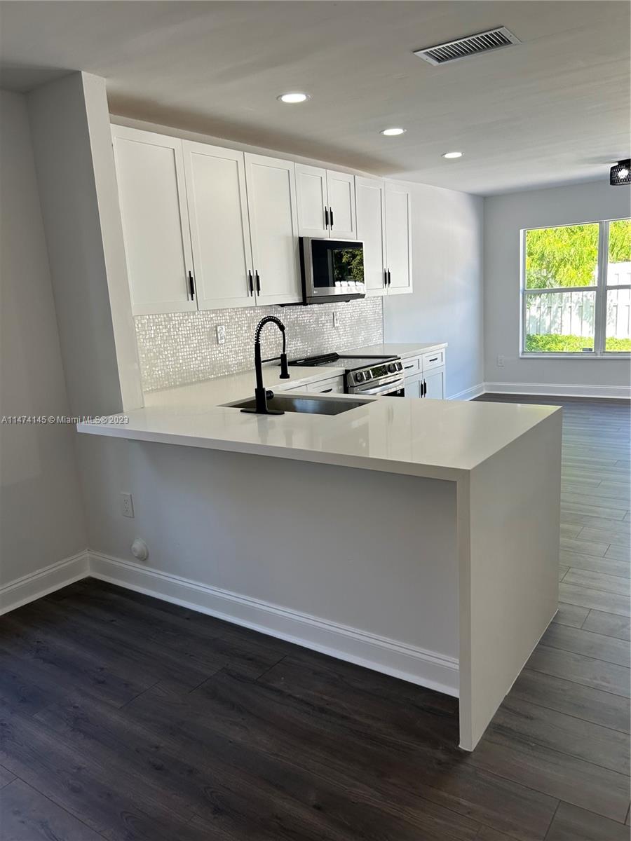 Three Lakes Miami, FL 33186 - Photo 8 of 32 a view of kitchen with wooden floor and window