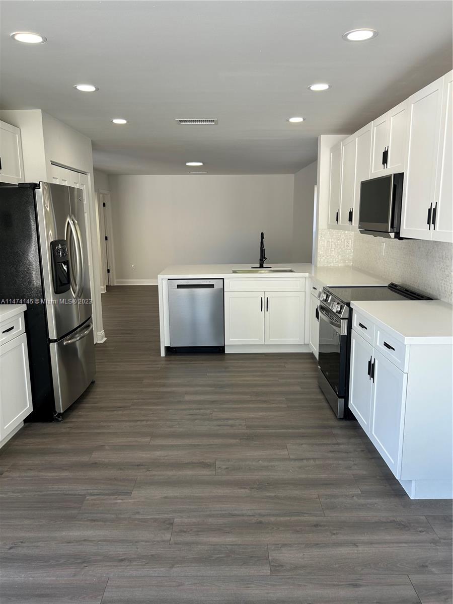Three Lakes Miami, FL 33186 - Photo 10 of 32 a kitchen with stainless steel appliances a refrigerator sink and white cabinets