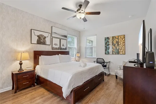 a bedroom with a bed and wooden floor