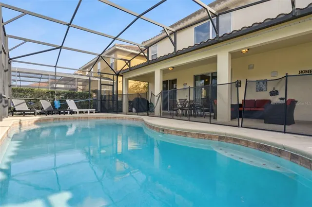 an aerial view of a house with a garden and lake view