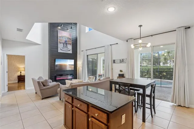 a kitchen with stainless steel appliances granite countertop a stove top oven a sink dishwasher a refrigerator and a microwave