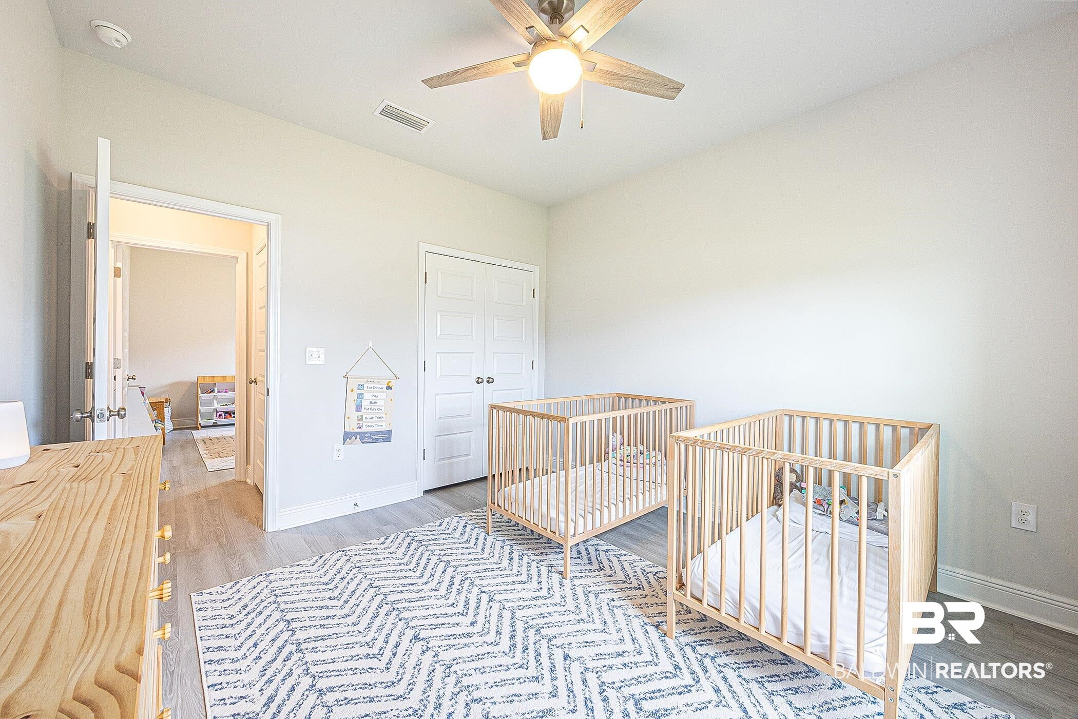11044 Native Dancer Way Daphne, AL 36526 - Photo 26 of 67 Bedroom featuring a crib, wood-type flooring, and ceiling fan