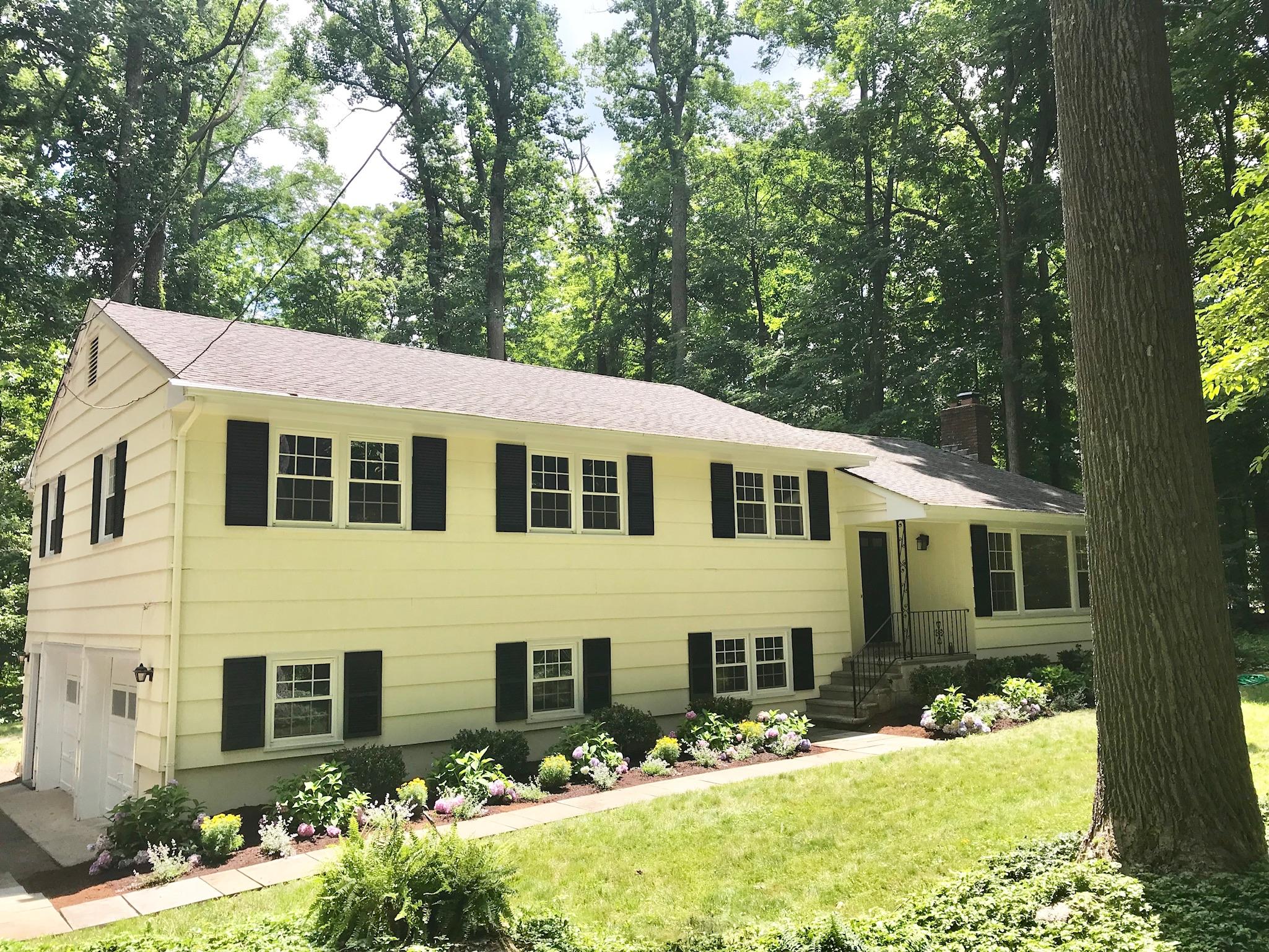 191 Laurel Road New Canaan, CT 06840 - Photo 1 of 39 a view of a house with a yard