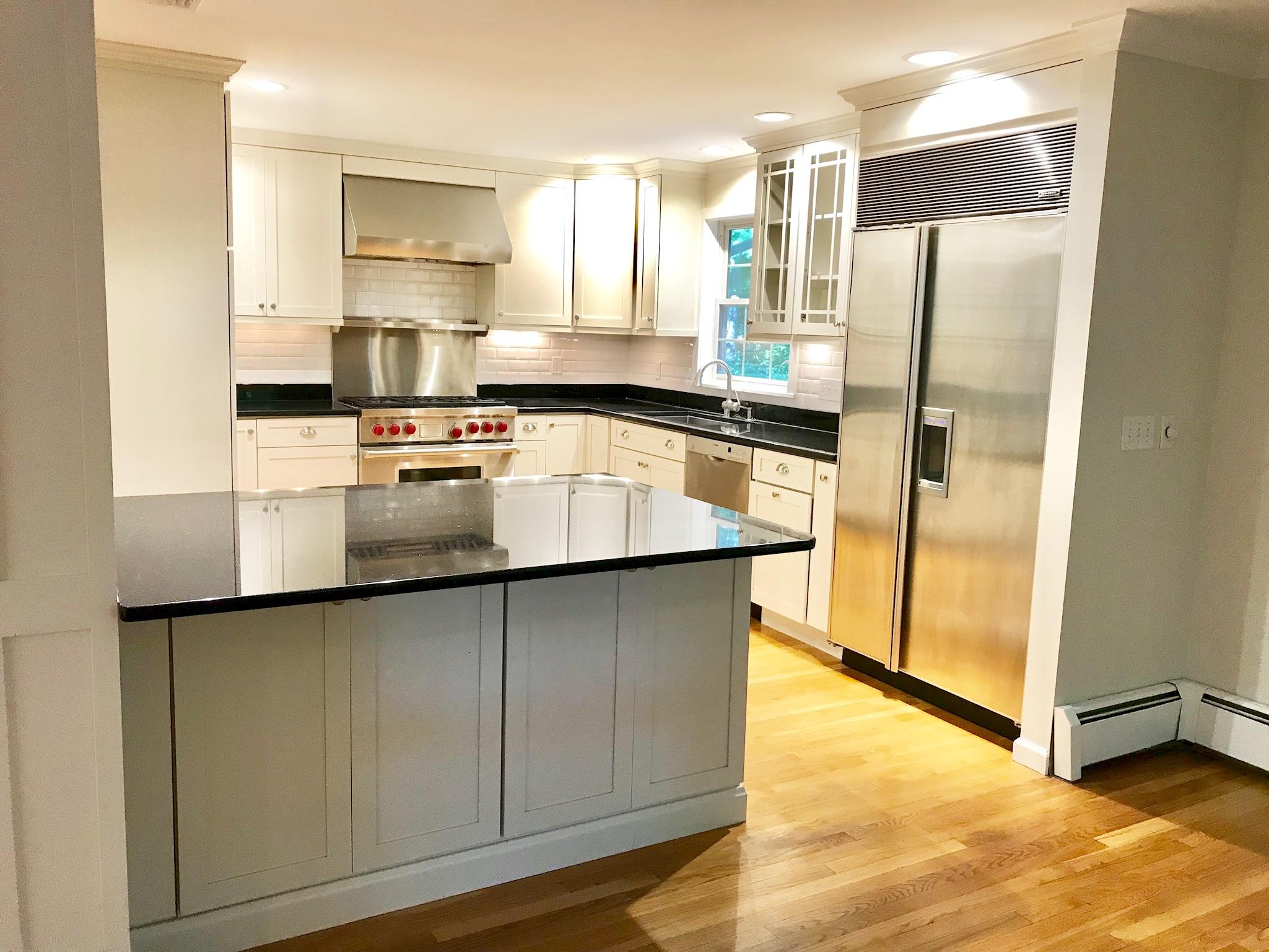 191 Laurel Road New Canaan, CT 06840 - Photo 12 of 39 a kitchen with stainless steel appliances a refrigerator and a stove