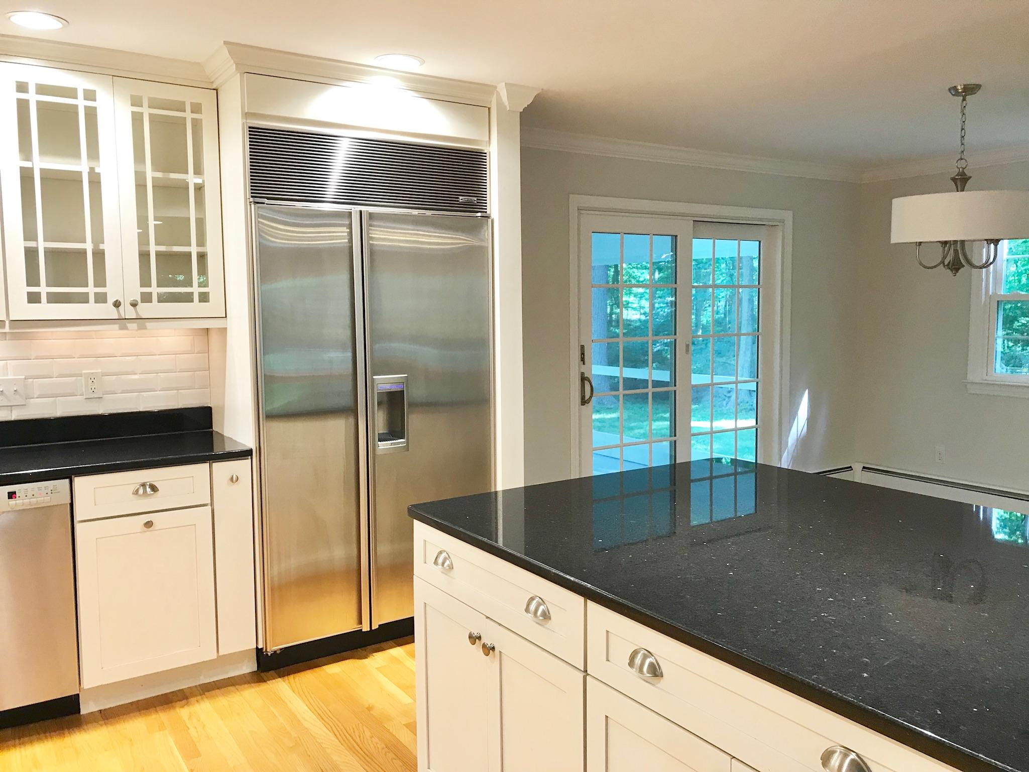 191 Laurel Road New Canaan, CT 06840 - Photo 15 of 39 a kitchen with granite countertop a refrigerator a sink and cabinets