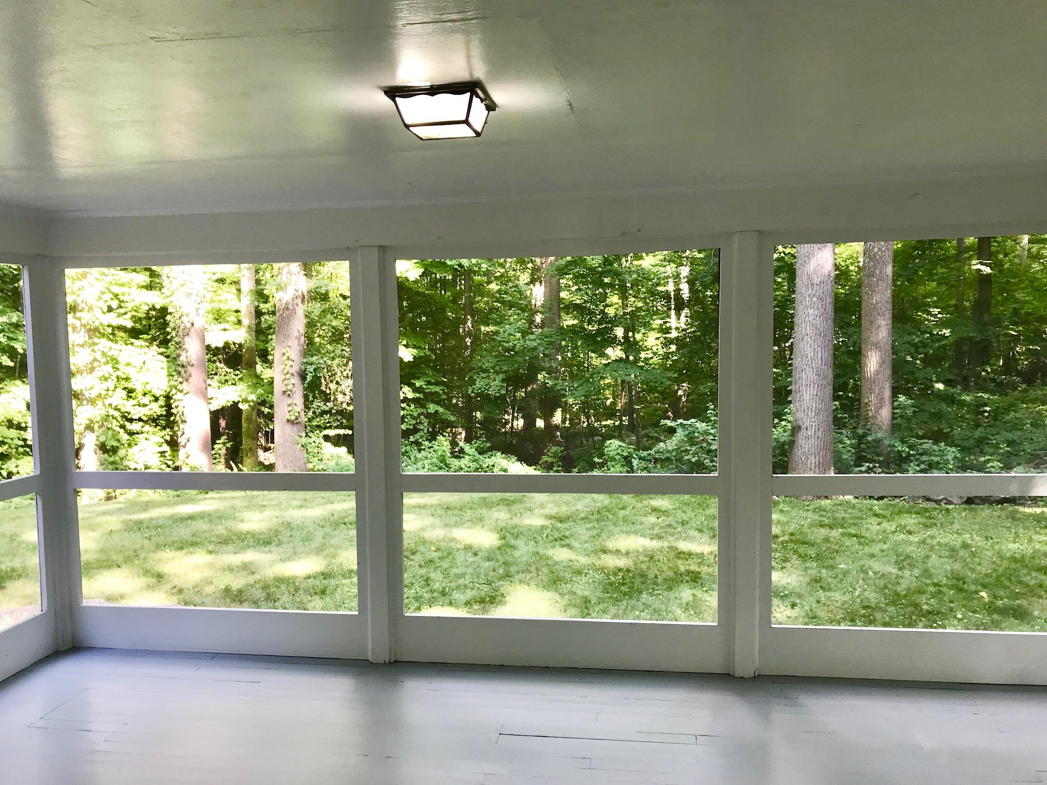 191 Laurel Road New Canaan, CT 06840 - Photo 16 of 39 a view of an empty room with wooden floor and windows