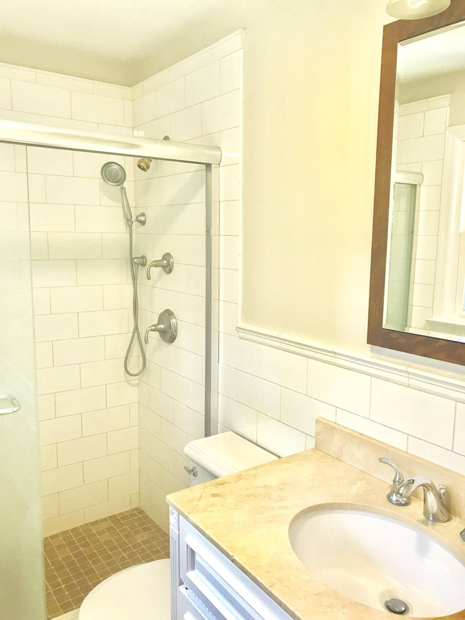 191 Laurel Road New Canaan, CT 06840 - Photo 21 of 39 a bathroom with a granite countertop shower sink and a mirror