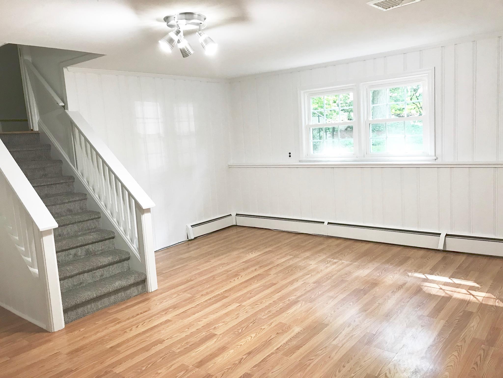 191 Laurel Road New Canaan, CT 06840 - Photo 29 of 39 a view of an empty room with wooden floor and a window