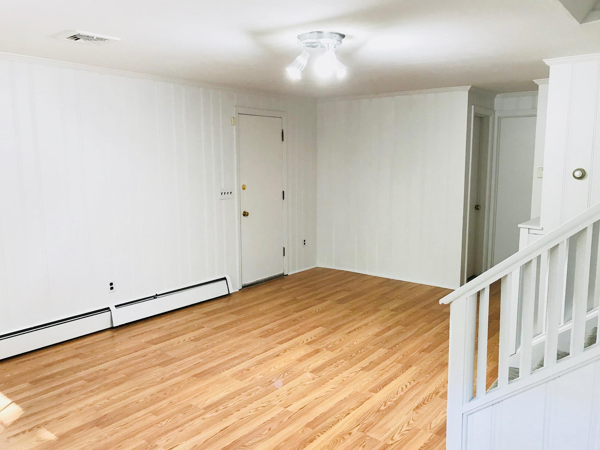191 Laurel Road New Canaan, CT 06840 - Photo 30 of 39 a view of an empty room with wooden floor