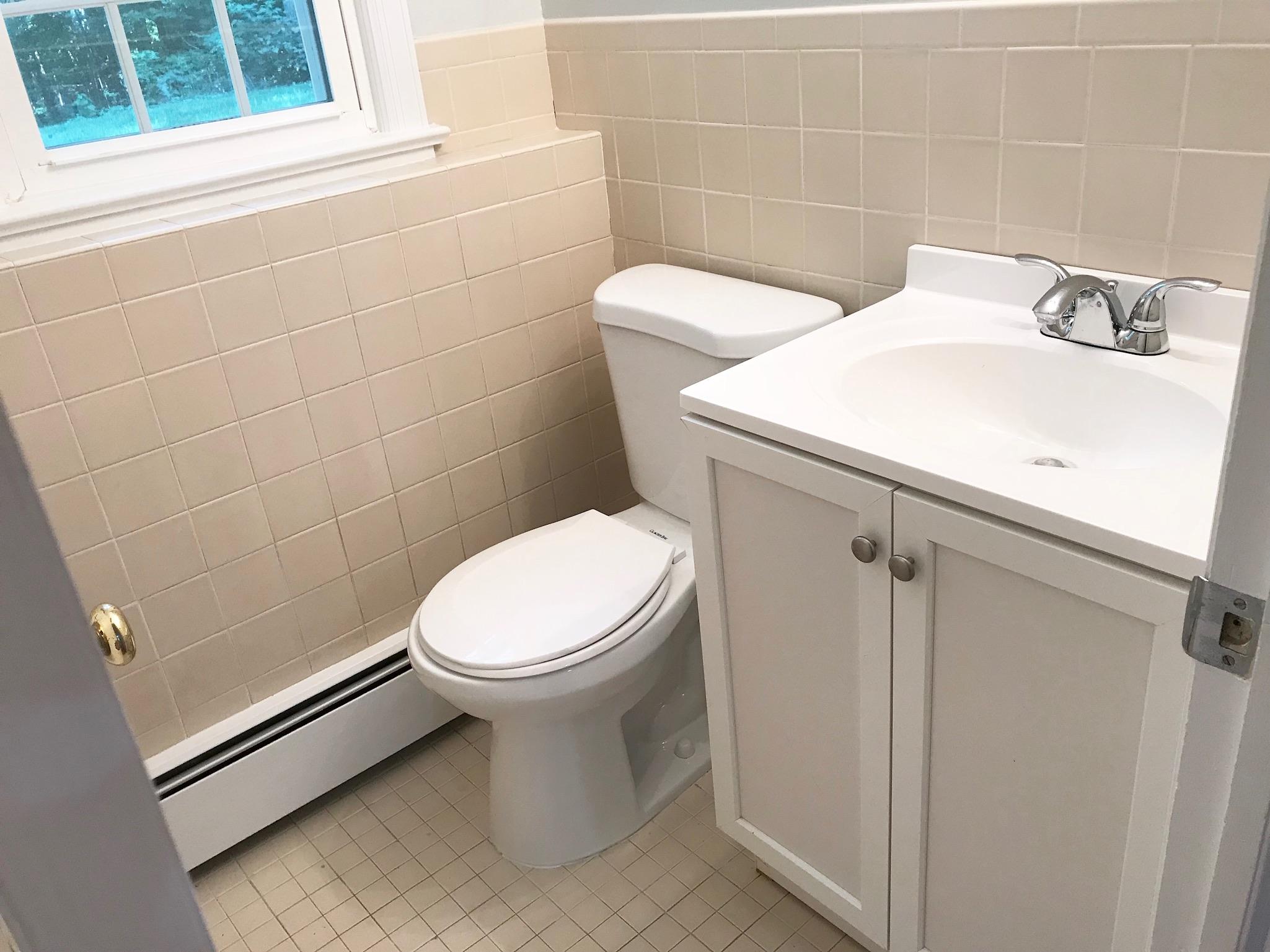 191 Laurel Road New Canaan, CT 06840 - Photo 33 of 39 a white toilet sitting next to a bathroom sink