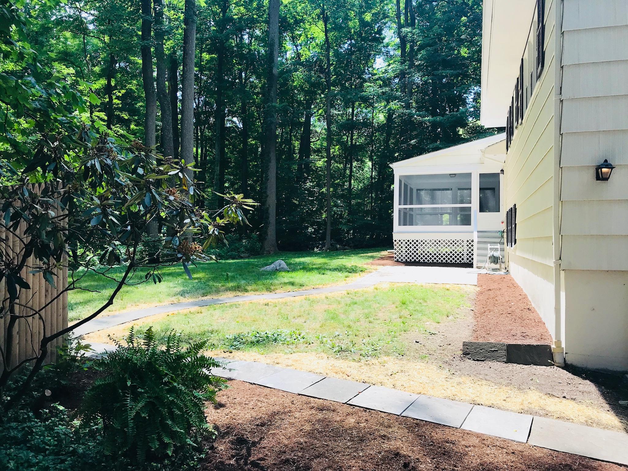 191 Laurel Road New Canaan, CT 06840 - Photo 34 of 39 a view of a backyard with a garden