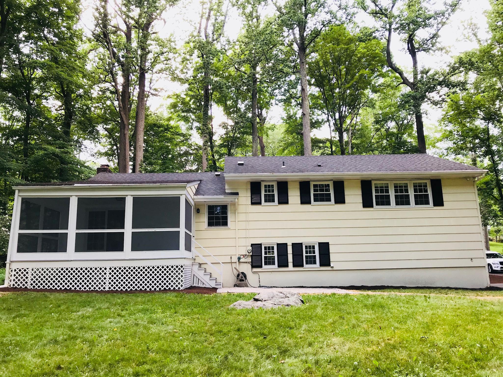 191 Laurel Road New Canaan, CT 06840 - Photo 35 of 39 a house with trees in the background