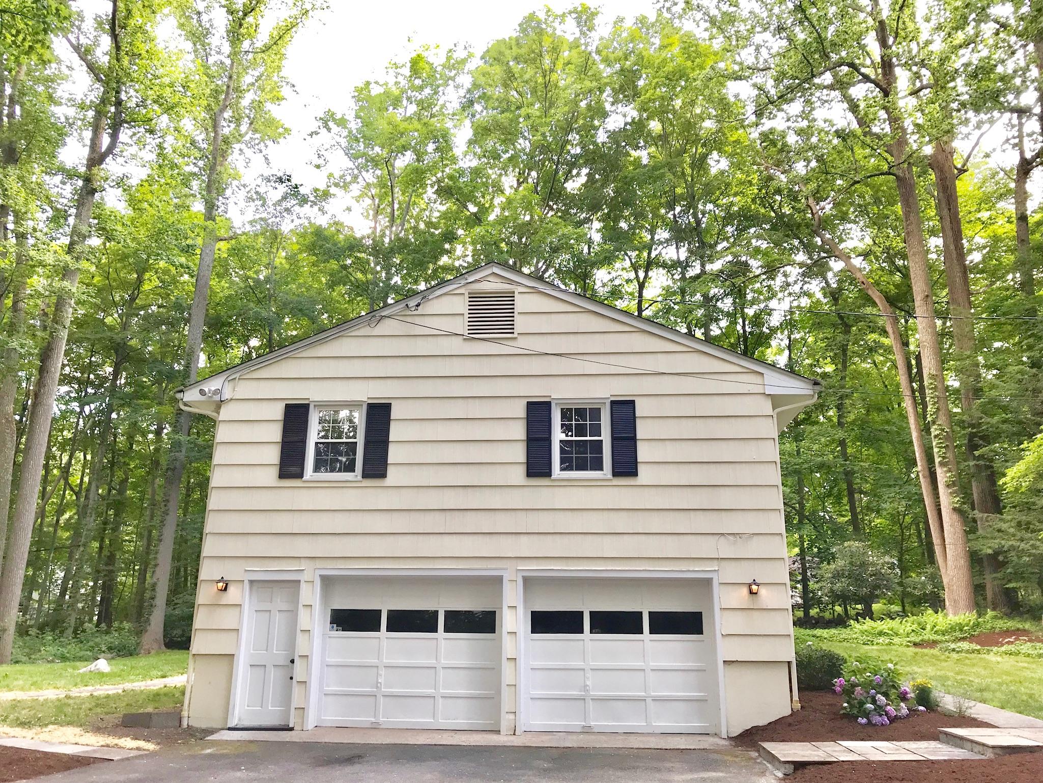 191 Laurel Road New Canaan, CT 06840 - Photo 38 of 39 a front view of a house with a yard