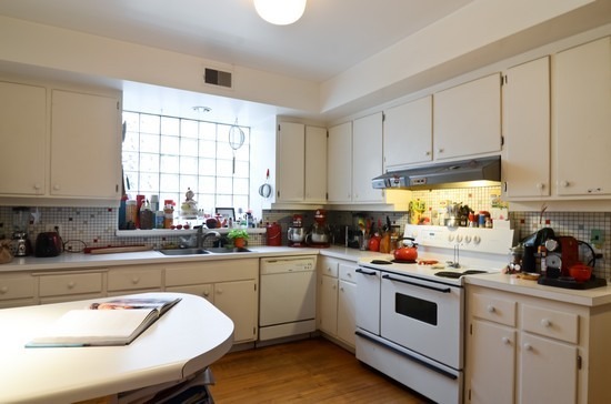 Undisclosed Address Chicago, IL 60647 - Photo 14 of 25 a kitchen with a sink white cabinets and white appliances