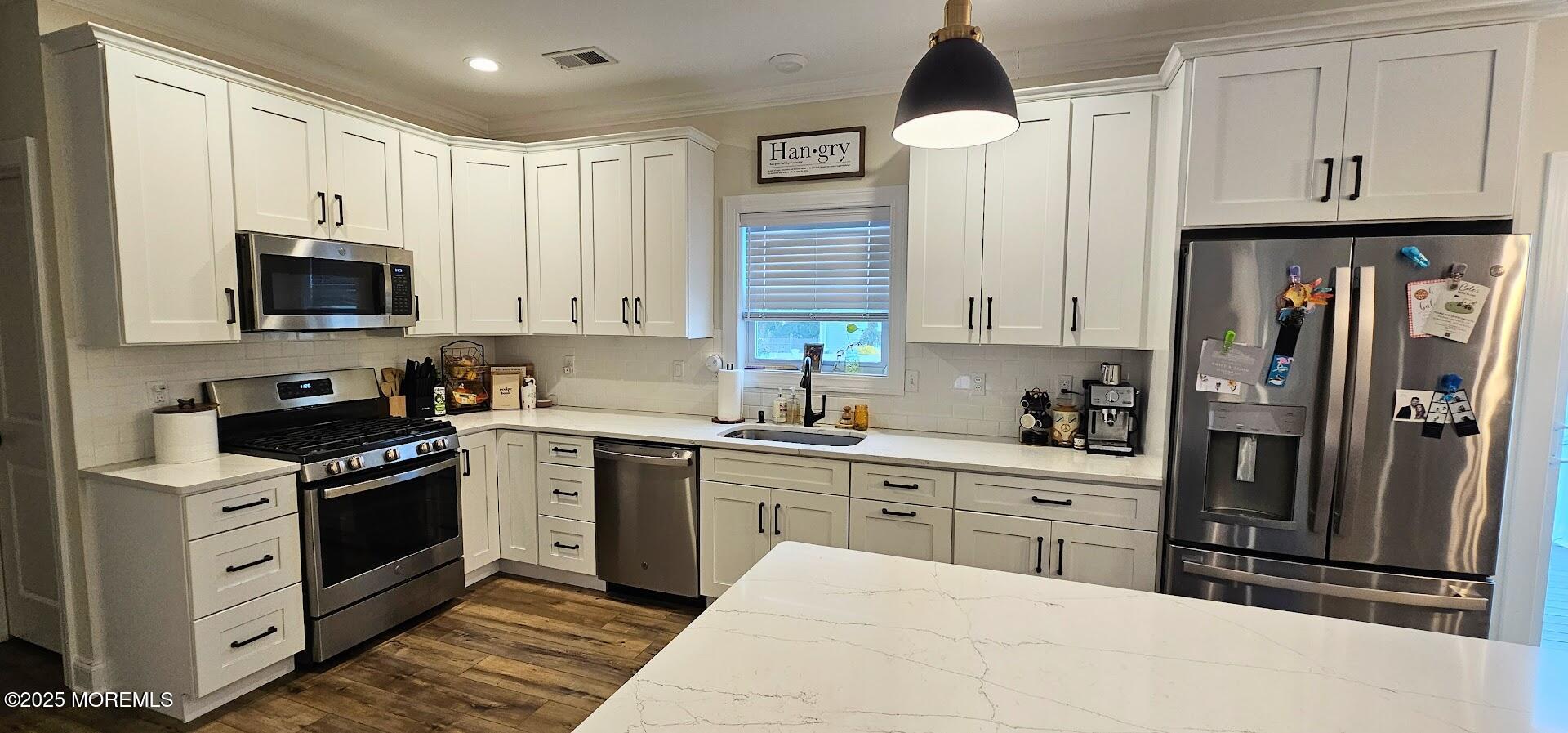 137 Jordan Road Brick, NJ 08724 - Photo 11 of 38 a kitchen with stainless steel appliances a stove refrigerator sink and cabinets