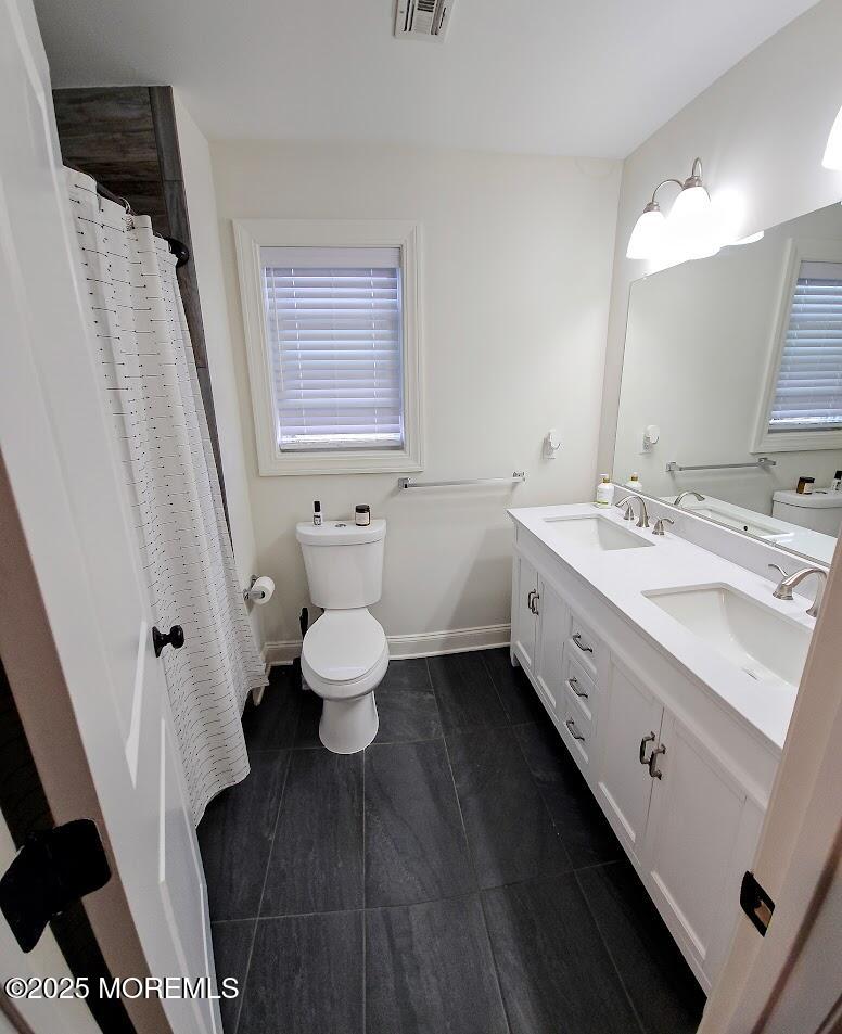 137 Jordan Road Brick, NJ 08724 - Photo 20 of 38 a bathroom with a double vanity sink toilet and a mirror