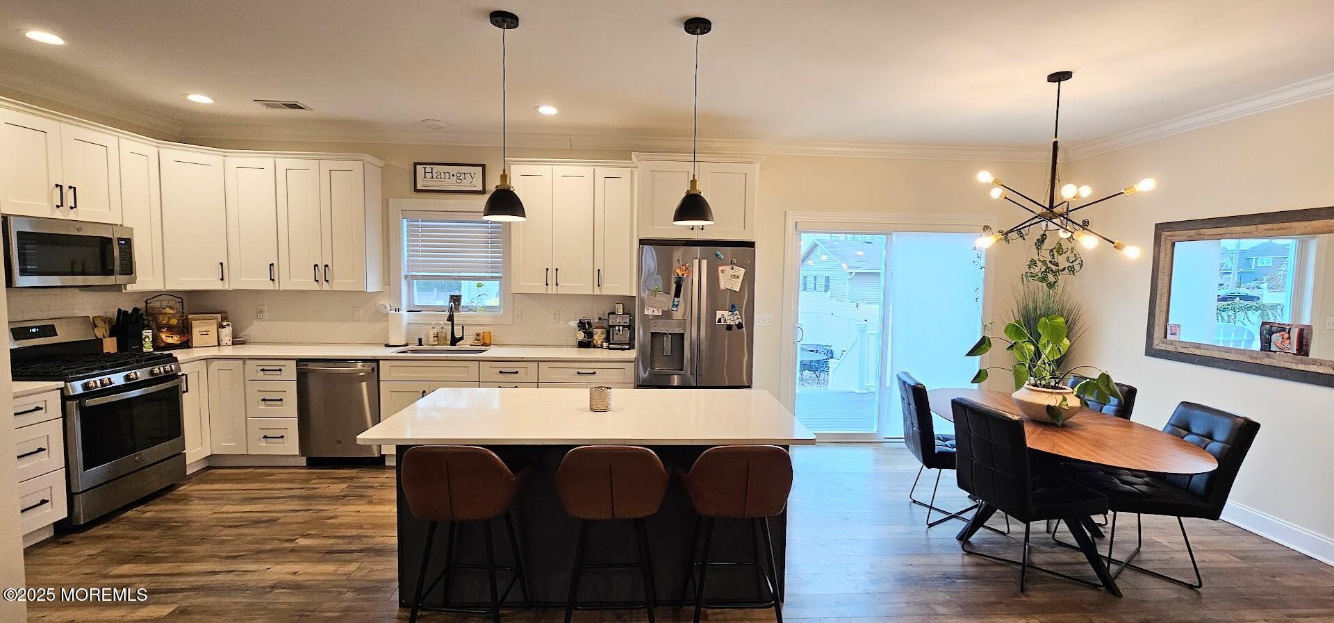 137 Jordan Road Brick, NJ 08724 - Photo 8 of 38 a kitchen with stainless steel appliances kitchen island granite countertop a table chairs and a refrigerator