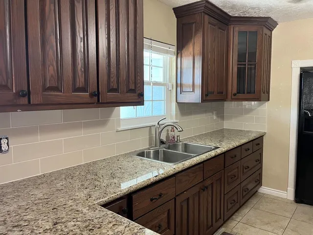 a kitchen with a refrigerator and a sink