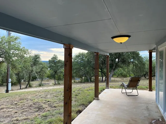 a view of a patio with chairs and table in the patio