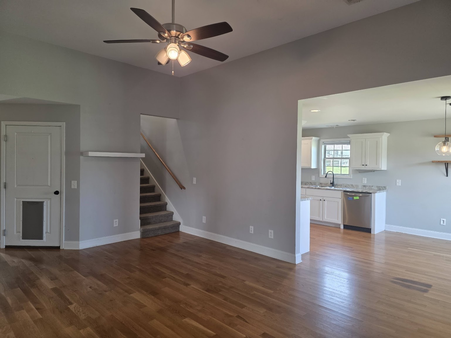 4927 Minnis Road Springfield, TN 37172 - Photo 3 of 15 a view of an empty room with wooden floor and a kitchen