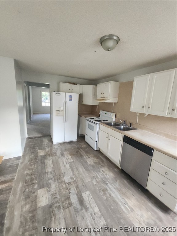 803 Antioch Church Road Dunn, NC 28334 - Photo 11 of 17 a large white kitchen with a stove a refrigerator and white cabinets