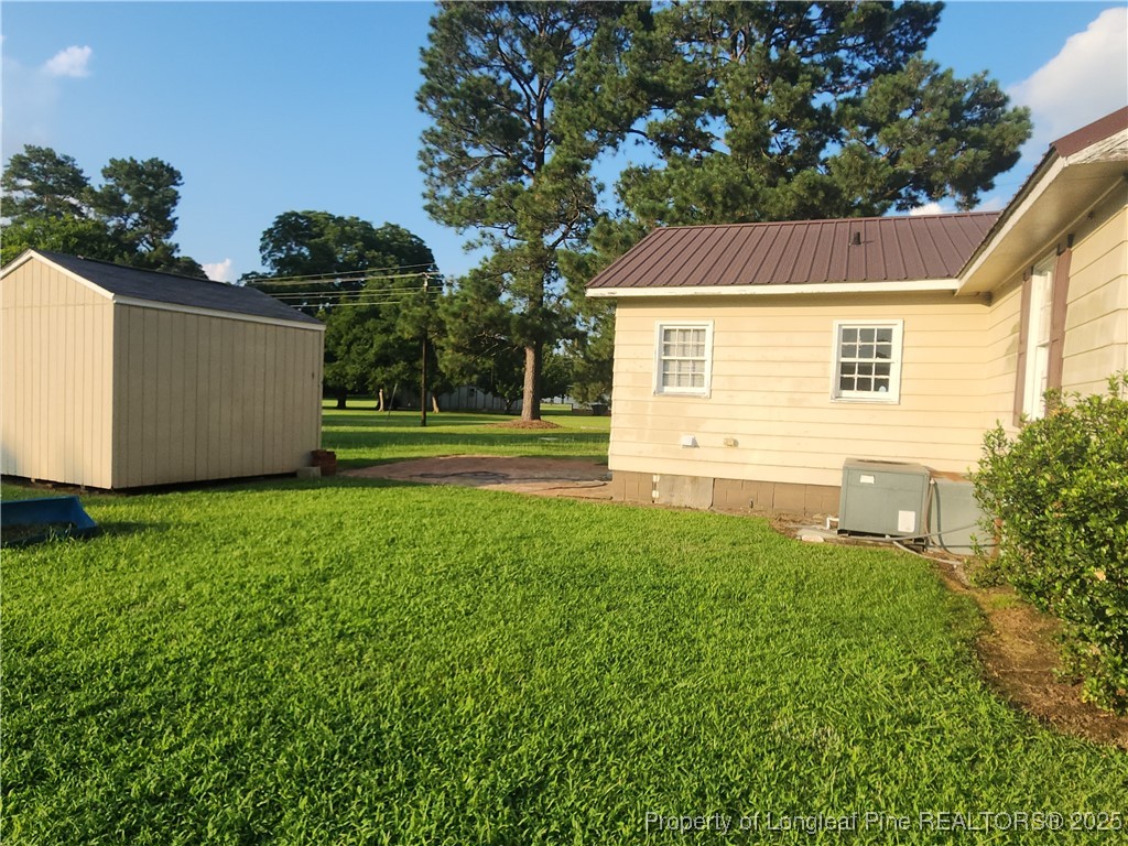 803 Antioch Church Road Dunn, NC 28334 - Photo 12 of 17 a view of a backyard with tree