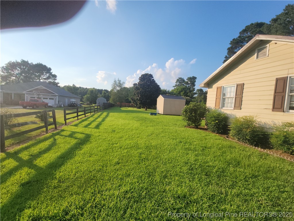 803 Antioch Church Road Dunn, NC 28334 - Photo 13 of 17 a view of a house with a yard and a garden