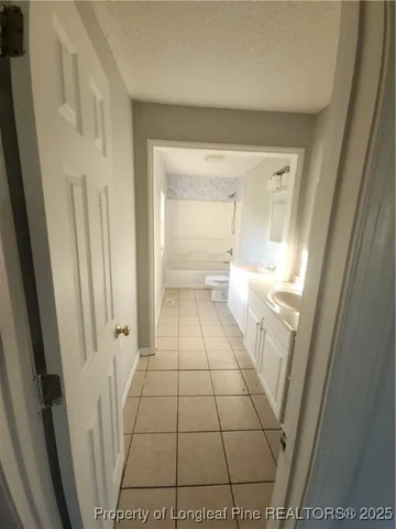 a bathroom with a sink a toilet and a shower