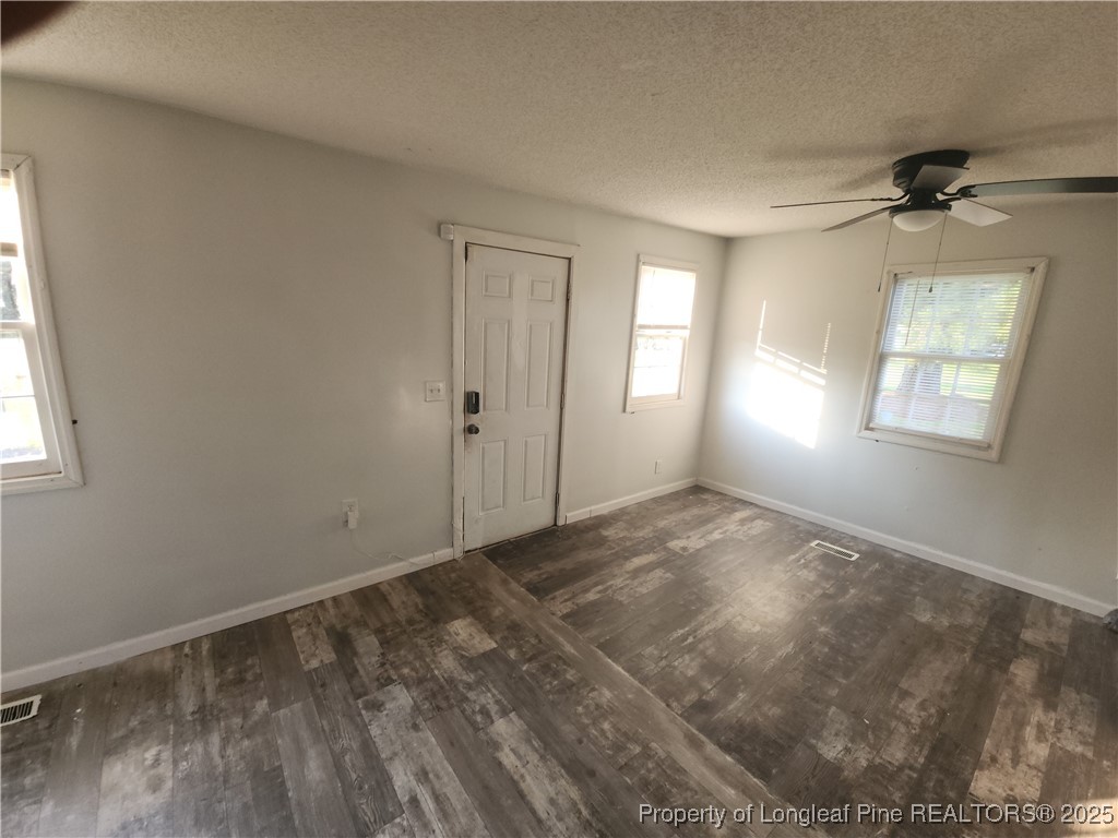 803 Antioch Church Road Dunn, NC 28334 - Photo 9 of 17 a view of empty room with windows
