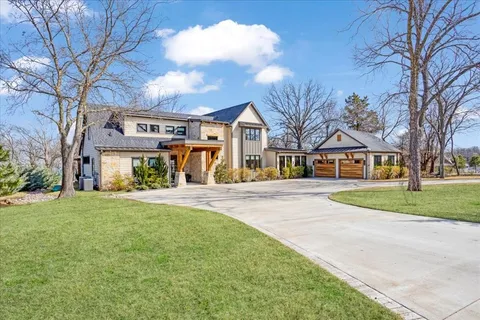 a view of house with outdoor space and garden