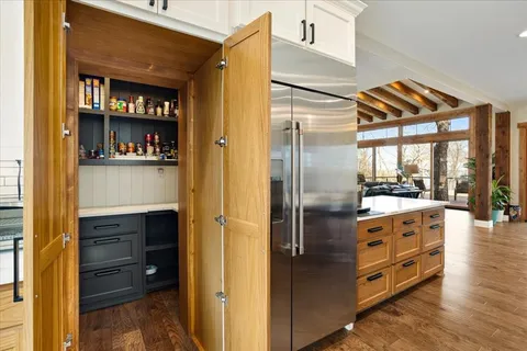 a kitchen with stainless steel appliances granite countertop a refrigerator and a stove